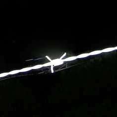 an airplane is flying in the dark with lights on it's tail and wings