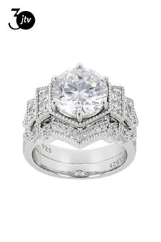 a white gold ring with diamonds on the sides and an oval center stone in the middle