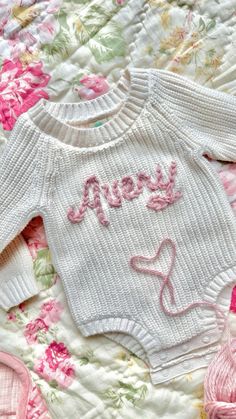 a baby sweater with the word hope written on it