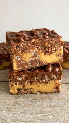 three pieces of chocolate and peanut butter fudge bars stacked on top of each other