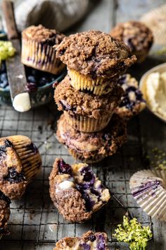 blueberry muffins stacked on top of each other with one bite taken out