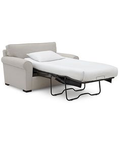 a couch with a pull out bed attached to the back of it's arm