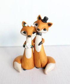 two small figurines sitting next to each other