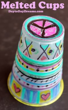 stacked cups with the words melted cups written on them in pink, blue and yellow