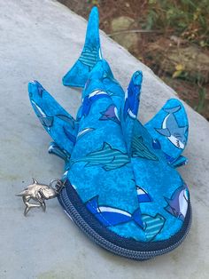 "Have a shark obsessed fan in your house? This is the perfect little bag to showcase that obsession. It can be used as a pencil holder, a change purse, or small crossbody bag. The bag measures 10\" from the mouth to end of tail. The usable space is 8\" from from the end of the mouth, which is long enough for a pencil. It is 4\" wide at the widest part. You can just purchase the zipper pouch or you can purchase the crossbody option which comes with a 56\" strap. (Strap length can be customized if Silly Sharks, Ocean Accessories, Shark Bag, Expo Ideas, Ocean Stuff, Shark Pictures, Hand Sanitizer Holder, White Dragon, Change Purse