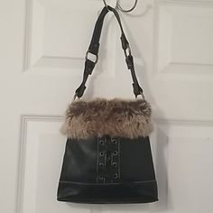 Nwot Faux Leather With Fur Trim Purse In Excellent Condition. Brass Accented Hoop Hardware. Front Has Crisscross Tie Design. Single Strap. Interior Has Zippered Pocket. Measurements Are Approximately 9"L X 8"H X 2 1/2"W. Leather Bag With Faux Fur Lining, Winter Leather Shoulder Bag With Faux Fur Lining, Leather Bags With Faux Fur Trim For Everyday Use, Fur Purse, Tie Design, Brass Accents, Fur Trim, Zipper Pocket, Black And Brown