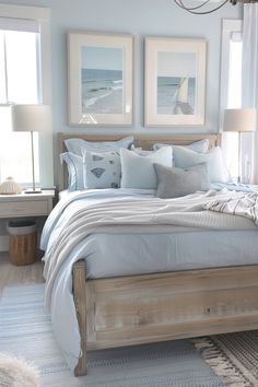 a bed with white sheets and pillows in a bedroom next to two pictures on the wall