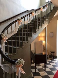 a staircase decorated with ribbons and flowers