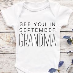 Introducing the new grandma personalized pregnancy announcement baby bodysuit! This adorable outfit is perfect for announcing your pregnancy to all of your friends and family. Not only is it a fun way to show off your growing bump, but it's also a unique gift idea for your grandparents or other relatives who are expecting. Whether you're planning a baby shower for your friends or just want to give your new grandmother a special gift, this outfit is sure to please. So don't wait any longer and or Family Matching Birthday Onesie With Funny Text, Family Matching Onesie With Funny Text For Birthday, Personalized Family Matching Onesie For Birthday, Personalized Birthday Onesie For Mother's Day, Summer Onesie With Letter Print For Gender Reveal, Family Matching Custom Print Onesie For Gender Reveal, Family Matching Onesie For Gender Reveal With Letter Print, Planning A Baby Shower, New Grandma