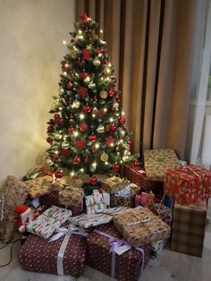 a christmas tree with presents under it