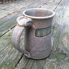 a ceramic mug sitting on top of a wooden table