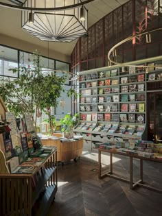 the inside of a book store with many books on shelves and tables in front of them