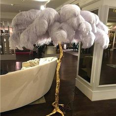 a large white feather tree in a living room