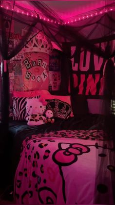 a bed covered in pink and black sheets