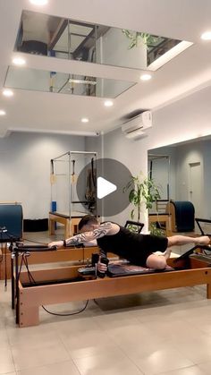 a person laying on a bed in a room with mirrors and other equipment around them