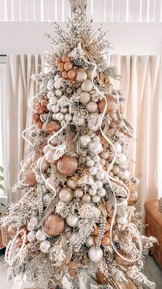 a white christmas tree decorated with ornaments