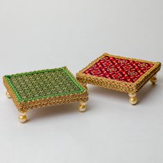 two small trays sitting on top of each other with beaded trim around them