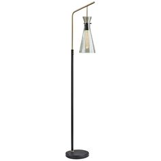 a black floor lamp with a clear glass shade on the top and a metal base