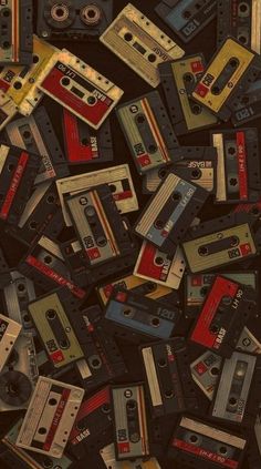 a pile of old cassette tapes sitting on top of each other