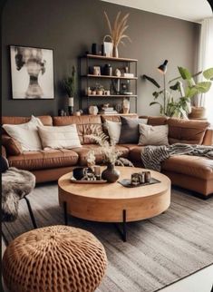 a living room filled with lots of furniture and plants on top of a table in front of a window