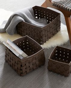 three brown baskets sitting on top of a rug