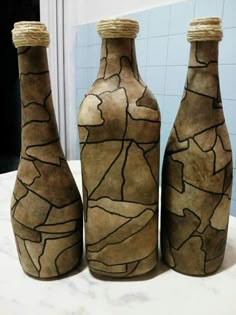 three brown vases sitting on top of a table