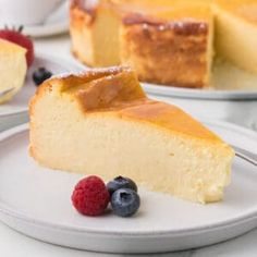 a piece of cheesecake on a plate with berries