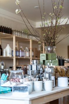 there are many items on the table in this room that is filled with coffee and tea