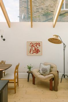 a living room filled with furniture and a painting on the wall