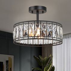 a round chandelier hanging from the ceiling in a living room