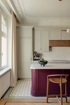 a kitchen with white cabinets and purple counter tops