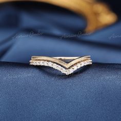 a diamond ring sitting on top of a blue cloth