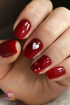 Add some sparkle to your fall nails with these red nails featuring a glittery silver heart and 3D accents. Perfect for a touch of glamour. Visit NailHow.com for more stunning nail designs and save this pin to your collection! Stunning Nail Designs