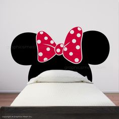 a minnie mouse wall decal with a pink bow on it's head and polka dots