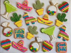 decorated cookies are arranged in the shape of hats, cactuses and sombreros