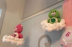 two stuffed animals are hanging from the ceiling