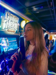 a woman is playing video games in a casino