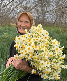 an older woman holding a bouquet of flowers