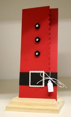 an image of a red object made out of paper with black buttons on the bottom