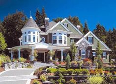 a large house with lots of windows and landscaping