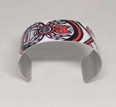 "This lightweight, adjustable aluminum cuff features artwork by Cherokee Nation artist, MaryBeth Timothy. The title of this image is \"SouthEast Spiders\". Although the art is done in a contemporary style, the designs on this cuff are actually a variety of ancient mound symbols found in or around the native burial mounds (Moundville, AL; Spiro, Ok; Etowah, GA; etc.). This cuff features the spider motif. The cuffs are easily squeezed and pulled apart to adjust to most adult sized wrists. Dimensio Hand Painted Adjustable Cuff Bracelet As Gift, Southeast Native Americans, Bookmark Printing, Metal Bookmarks, The Spider, Spiders, Cuff Bracelet, Nativity, Contemporary Style