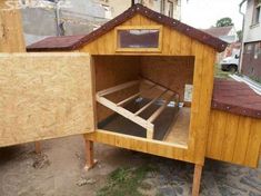 a chicken coop built into the side of a building