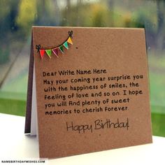 a birthday card with a message written on it sitting in front of a glass window