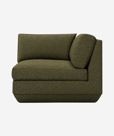 a green couch sitting on top of a white floor