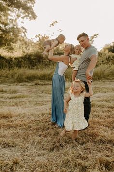 an adult and two children standing in a field