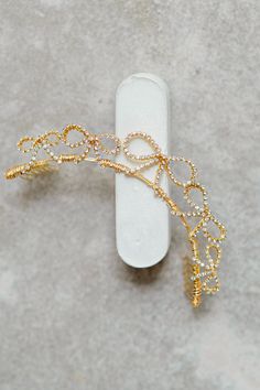 a piece of jewelry sitting on top of a white object