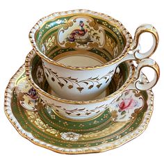 an ornately decorated tea set with matching saucers and cups is shown on a white background