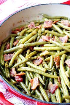 green beans with bacon in a pan on a red and white checkered table cloth