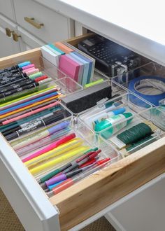 an organized drawer with pens, markers and pencils