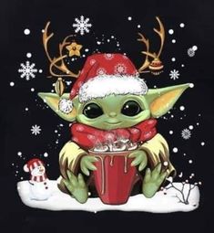 a baby yoda wearing a santa hat and holding a cup in front of snow